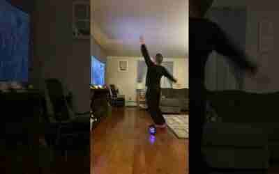 Guy’s First Time on a Hoverboard as He Barely Tries to Keep His Balance Close to a TV